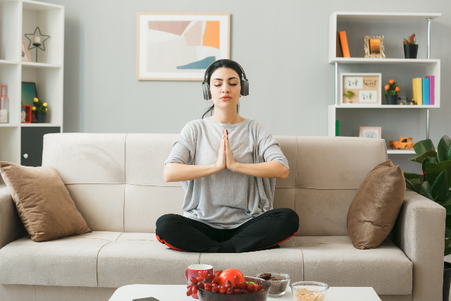 A person breathing deeply in a light-filled room after energy cleansing after life crisis.